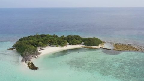 Drone view of beautiful Maldives island. Tropical beach white sand, blue Indian Ocean palm trees. Vacation on paradise island : Beach and sea and sky.