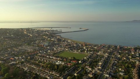 Dun Laoghaire Rathdown, Dublin, Ireland, April 2020. Drone flies over Sandycove, looking towards Hudson Road Park and Dun Laoghaire Harbour with Poolbeg Power Station on Horizon.