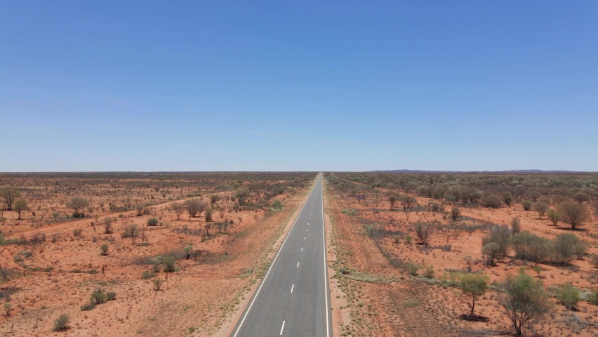 Cars Driving At Long Straight Road In Middle Of Desert - Uluru-Kata Tjuta National Park In Northern Territory, Australia. - aerial