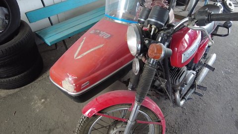 The city of Kiev. Ukraine. March 20, 2021. old motorcycle with a kalyaska. The Old Rarity Tricar. vintage motorcycle red