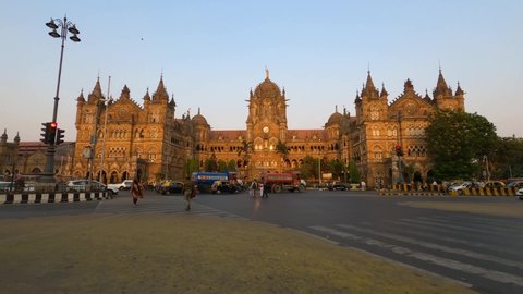 Mumbai, Maharashtra, India - March 15, 2021 - 4K Still Timelapse of vehicle traffic outside Chhatrapati Shivaji Terminus (CST) Railway station during sunset. Time lapse of people, cars during evening.