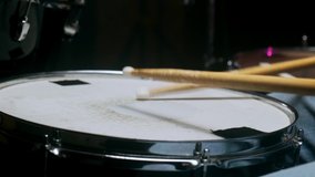 The drummer plays with sticks on a snare drum, home lesson training.