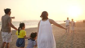 Happy big Asian family on beach holiday travel vacation. Multi-generation family enjoy outdoor lifestyle walking together on the beach at summer sunset. Grandparent embracing grandchild girl with love - Powered by Shutterstock - Get 15% off with code: PIKWIZARD15