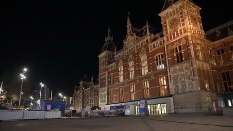 AMSTERDAM, NETHERLANDS – 5 MARCH 2021: Empty entrance to central train station in Amsterdam, night-time curfew in the Netherlands (Covid-19 coronavirus regulation).