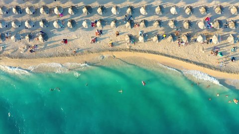 Beach and blue water. Top view from drone at the beach and blue sea. Travel and vacation video. Summer seascape.