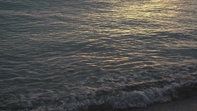 Beautiful morning sunrise peaceful sea water splashing on sunny summer tropical beach. Abstract natural 4k video background