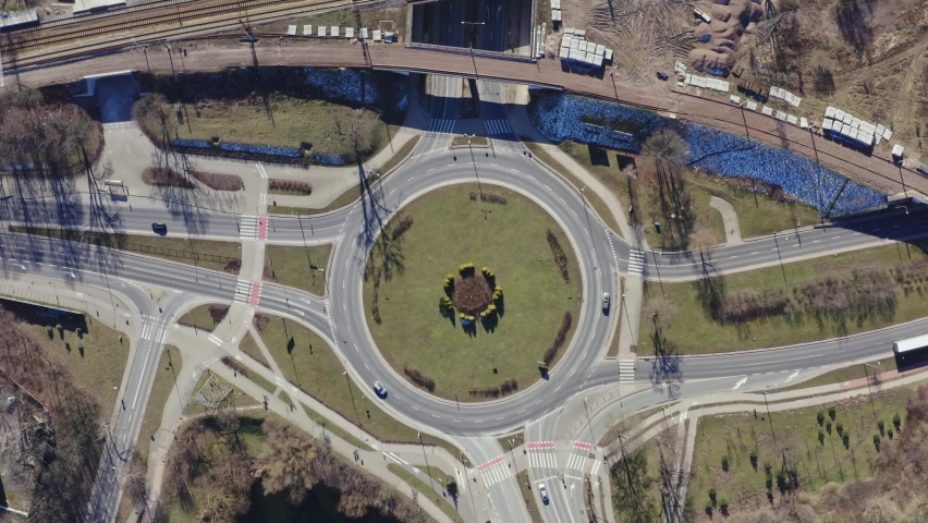 Aerial view above roundabout fly down. Top down aerial view on a circular with small Car Traffic. 4K 
