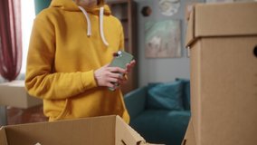 Customer paying for delivery using NFC technology with phone and credit card, contactless payment with student girl to professional mover. Cell phone. New flat or office. Daylight close up - Powered by Shutterstock - Get 15% off with code: PIKWIZARD15