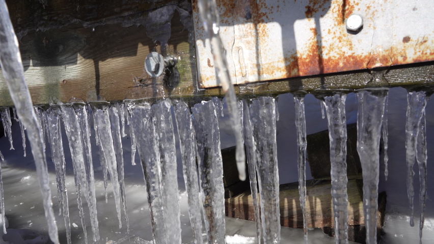 Rusty bridge with ice Stalactites formatin