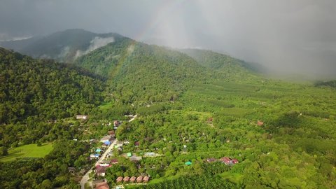 Rainbow Above Village in Jungle, Southeast Asia, Hope Concept, Aerial Descending
