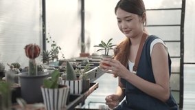 Beautiful woman happy and smiling at the camera while taking care of the plants in the greenhouse. Hobbies and activities while stay at home against coronavirus(covid-19) pandemic, new normal concept. - Powered by Shutterstock - Get 15% off with code: PIKWIZARD15