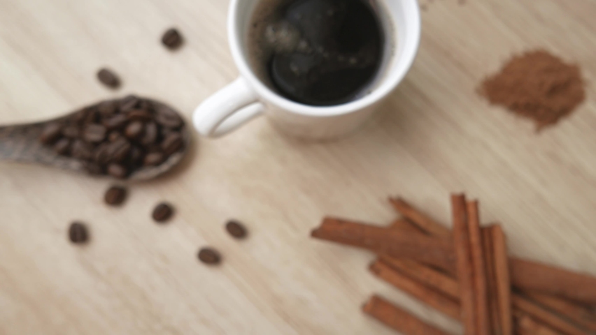 Coffee cup with coffee beans with cinnamon and star anise , Move towards the object