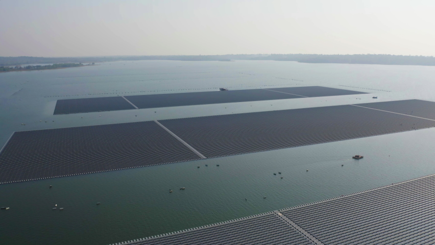 Aerial top view of solar panels or solar cells on buoy floating in lake sea or ocean. Power plant with water, renewable energy source. Eco technology for electric power in industry. Royalty-Free Stock Footage #1069578481