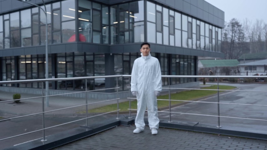 handsome asian scientist in protective suit