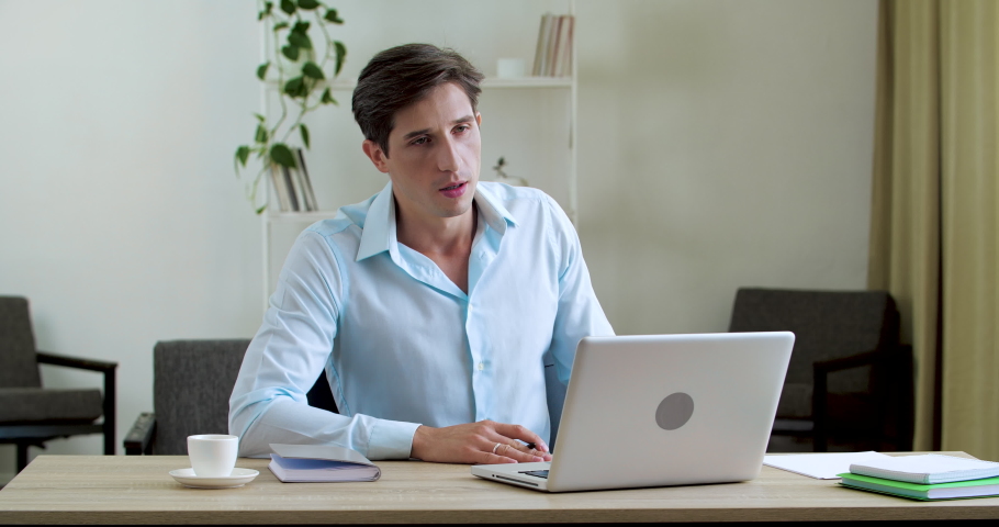 Tired male employee waving notebook like fan out feels uncomfortable hot in summer weather problem. Business man suffers of broken air conditioner in home office. Overheated from heat people Royalty-Free Stock Footage #1069586896