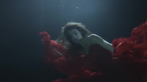 girl in a dress under water