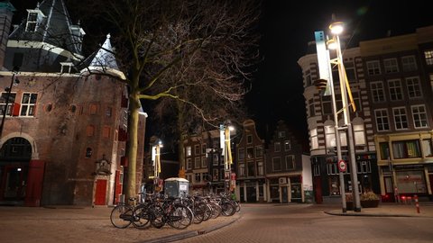 AMSTERDAM, NETHERLANDS – 5 MARCH 2021: Empty streets in 'Nieuwmarkt', a popular area in central Amsterdam with historic architecture. Coronavirus Covid-19 evening curfew and lockdown measures.