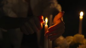 set fire to christmas dinner candles. A young woman lights a candle while waiting for his wife for a romantic dinner. Girl prepares anniversary celebration, romantic date at the table in the kitchen. - Powered by Shutterstock - Get 15% off with code: PIKWIZARD15