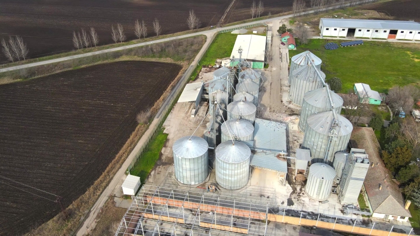 Silos complex outdoors. Steel storage for agricultural harvest. Grain tank. Silos landmark. Aerial top view. Seasonal storage. Corn sotrage.