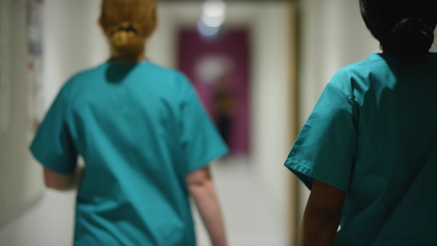 Blurred Medical Staff Walking Away  In Hospital Corridor Royalty-Free Stock Footage #1069605721
