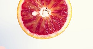 Video of rotating grapefruit citrus fruit on white studio background. Vitamins, healthy dieting concept, close up