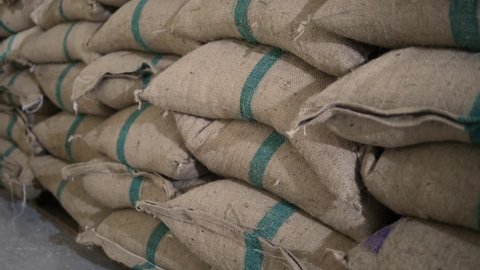 Bags of grain in the warehouse. Folded bags of coffee.