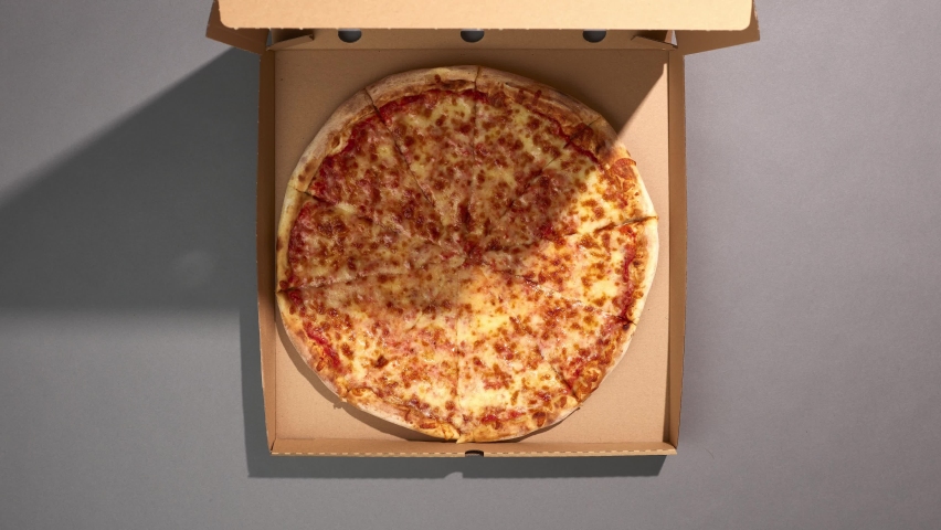 Top view of delivering a pizza box. Pizza slices disappear. Stop motion animation. | Shutterstock HD Video #1069611487