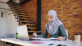 Modern arab woman wearing a hijab presents a new interior project remotely. Online presentation of the project, professional activities of women in the middle east