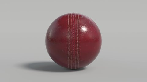 Side on view of a 3D cricket ball slowly rolling on the spot. Shiny red cricket ball in a continuous roll perfect for sports advertising. 4K clip at 30fps for smooth motion with an alpha matte.
