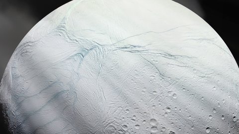 Surface of the Icy Moon Enceladus, Moon of Saturn, and Sun Rays. Elements of this Video furnished by NASA. 4K Resolution. 