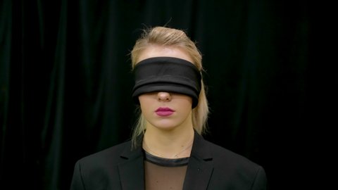Portrait sectarian woman with black blindfolded. Cult blind people. Mind confusion. Extrasensory feelings. Girl meditation blindfolding. Female psychic. Face bondage. Hypnotic trance illusion sect.