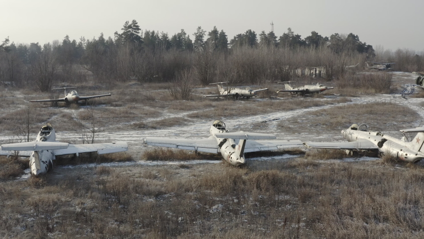 Several abandoned fighter planes at the military training ground - a cemetery of military equipment on an abandoned aerodrom. Forgotten strategic military base of the Soviet Union.