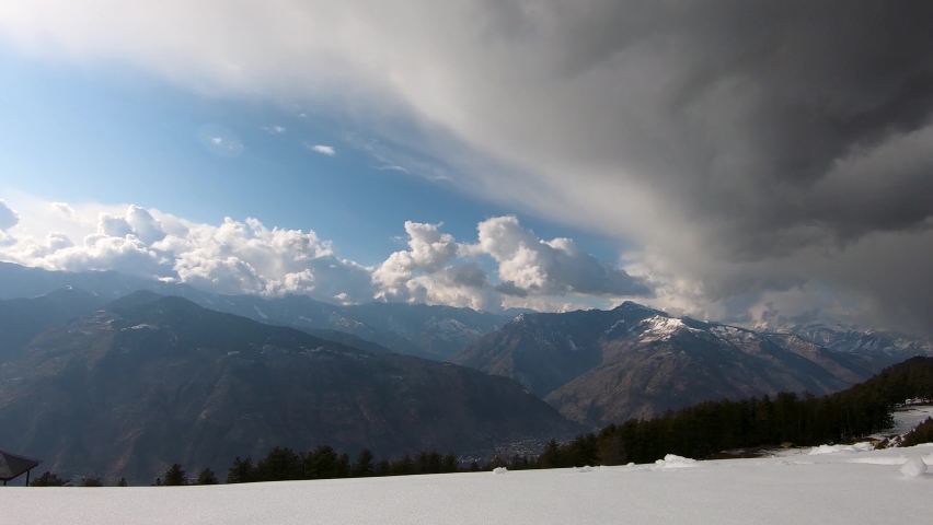 Timelapse of the stormy clouds above the mountain peaks of Kullu valley covered by snow as seen from the Bijli Mahadev temple near Manali in Himachal Pradesh, India | Shutterstock HD Video #1069629154