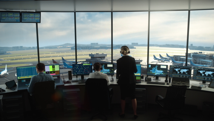 Diverse Air Traffic Control Team Working in a Modern Airport Tower. Office Room is Full of Desktop Computer Displays with Navigation Screens, Airplane Flight Radar Data for Controllers. | Shutterstock HD Video #1069631269