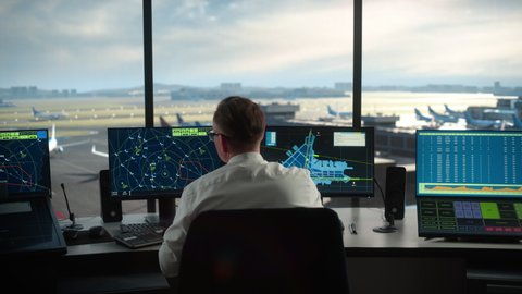 Diverse Air Traffic Control Team Working in a Modern Airport Tower. Office Room is Full of Desktop Computer Displays with Navigation Screens, Airplane Flight Radar Data for Controllers.