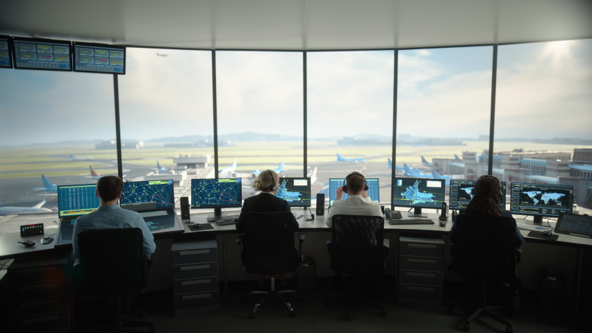 Diverse Air Traffic Control Team Working in a Modern Airport Tower. Office Room is Full of Desktop Computer Displays with Navigation Screens, Airplane Departure and Arrival Data for Controllers. | Shutterstock HD Video #1069631317