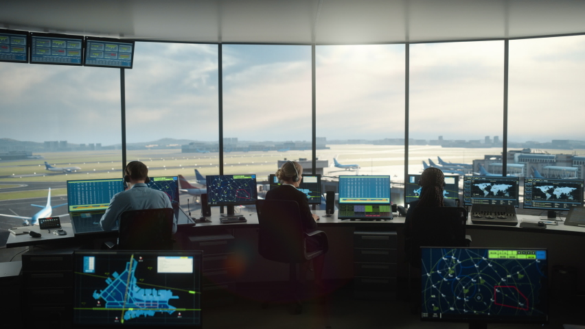Diverse Air Traffic Control Team Working in a Modern Airport Tower. Office Room is Full of Desktop Computer Displays with Navigation Screens, Airplane Flight Radar Data for Controllers. | Shutterstock HD Video #1069631440