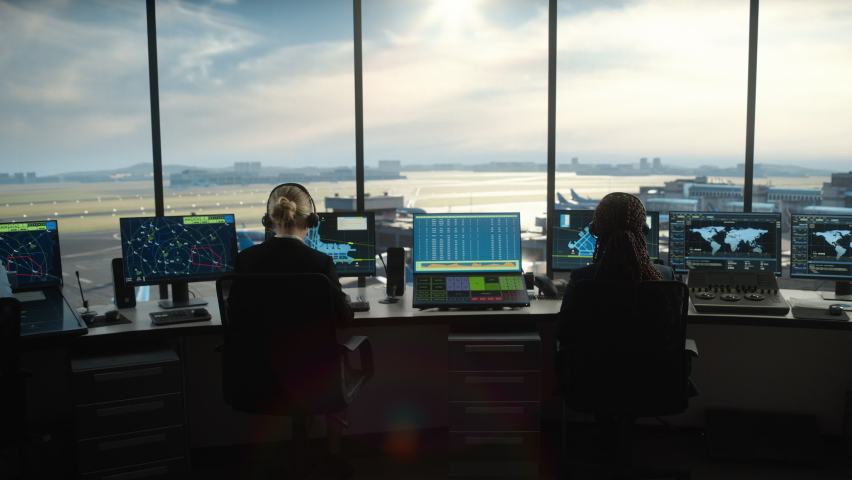 Diverse Air Traffic Control Team Working in a Modern Airport Tower. Office Room is Full of Desktop Computer Displays with Navigation Screens, Airplane Flight Radar Data for Controllers. | Shutterstock HD Video #1069631461