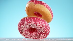 Delicious donut falls on pastel background. Super Slow motion - Powered by Shutterstock - Get 15% off with code: PIKWIZARD15