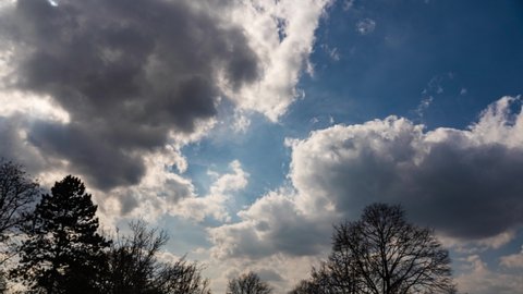 timelapse of a sunny but cloudy day. At he end you see a plane through the clouds