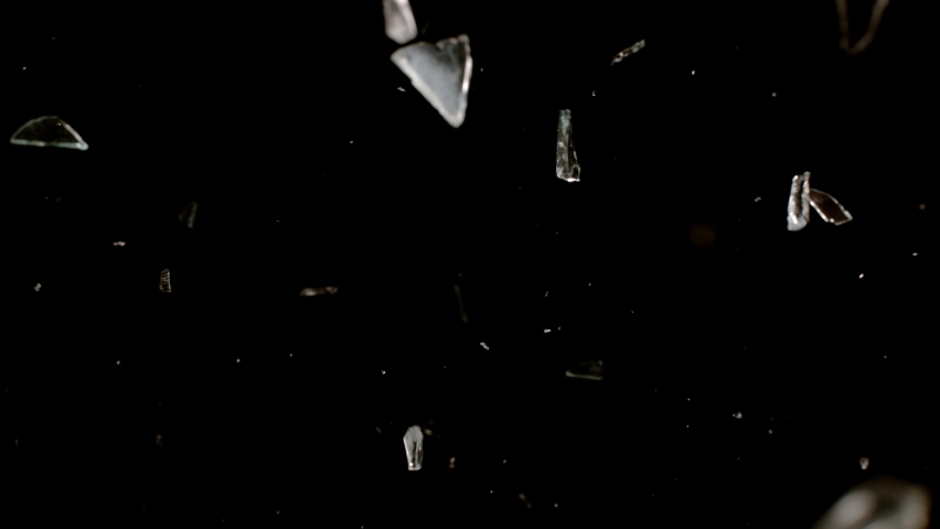 Shattered and broken glass shards flying through the air after crush broken window on a black background Royalty-Free Stock Footage #1069662223