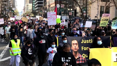 San Francisco, CA - Mar 26, 2021: 4K HD video of hundreds of unidentified participants at a youth lead anti-Asian Violence March walking down Market Street