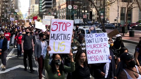 San Francisco, CA - Mar 26, 2021: 4K HD video of hundreds of unidentified participants at a youth lead anti-Asian Violence March walking down Market Street
