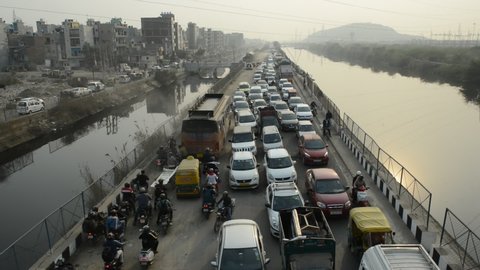 Ghaziabad, Uttar Pradesh, India-2 February 2021: Heavy traffic on Hindon Canal Road near Delhi Ghaziabad border after the farmers tractor rally, police sealed the border with barrier and barbed wire.