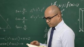 Young asian teacher man teaching video conference with student. Male Indian teacher training the mathematics in classroom from online course.