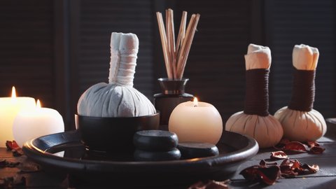 Spa background. Candles, massaging stones and herbal balls. Massage, oriental therapy, wellbeing and meditation.