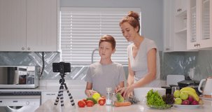 Food blogger woman and a child boy talking about healthy food to the camera, food vlog.