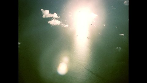 1940s Bikini Atoll: bright blast rings. Atomic bomb detonation test, with condensation rings. Mushroom cloud and central column of smoke.