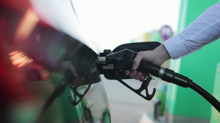 Filling car with gas fuel at station pump. Car filling up with fuel. Diesel Oil. Gas nozzle in car's fuel tank. Fuel, gas station, petrol prices concept. Royalty-Free Stock Footage #1069694431