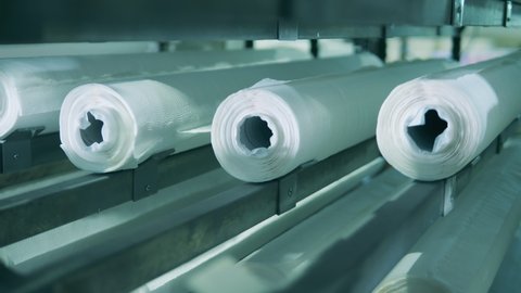 Close up shot of vertical paper roll conveyor